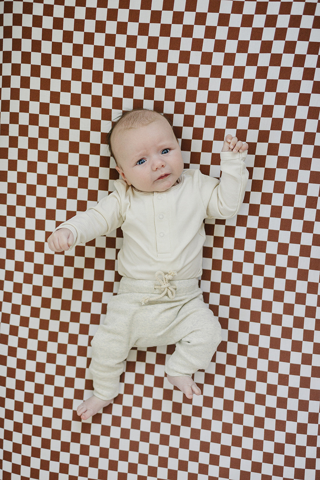 Soft texture close up of the Cream Bamboo Snap Long Sleeve Ribbed Bodysuit, a gentle long sleeve baby bodysuit for babies