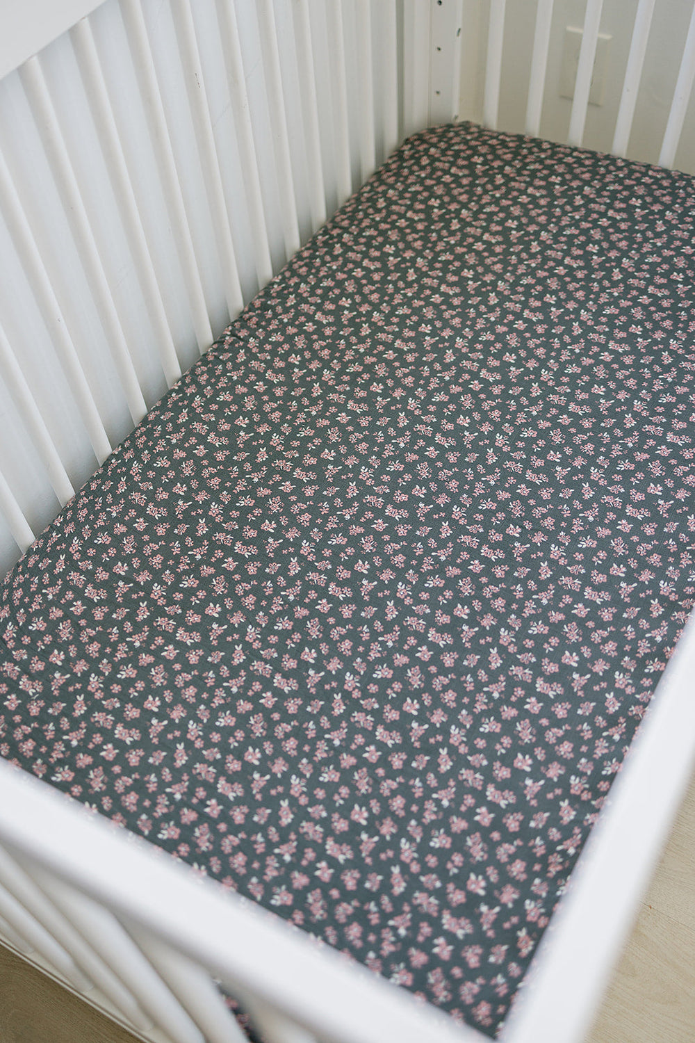 The Mebie Baby Olive Bloom Muslin Crib Sheet offers a snug and breathable fit, ideal fitted crib sheets for infants.