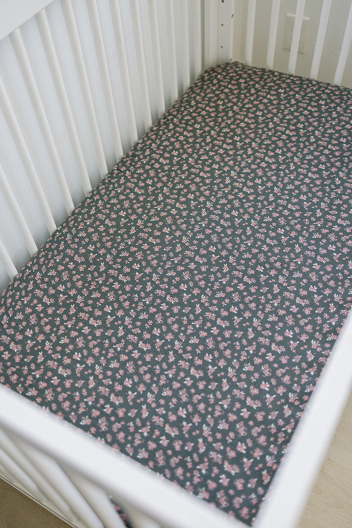 The Mebie Baby Olive Bloom Muslin Crib Sheet offers a snug and breathable fit, ideal fitted crib sheets for infants.