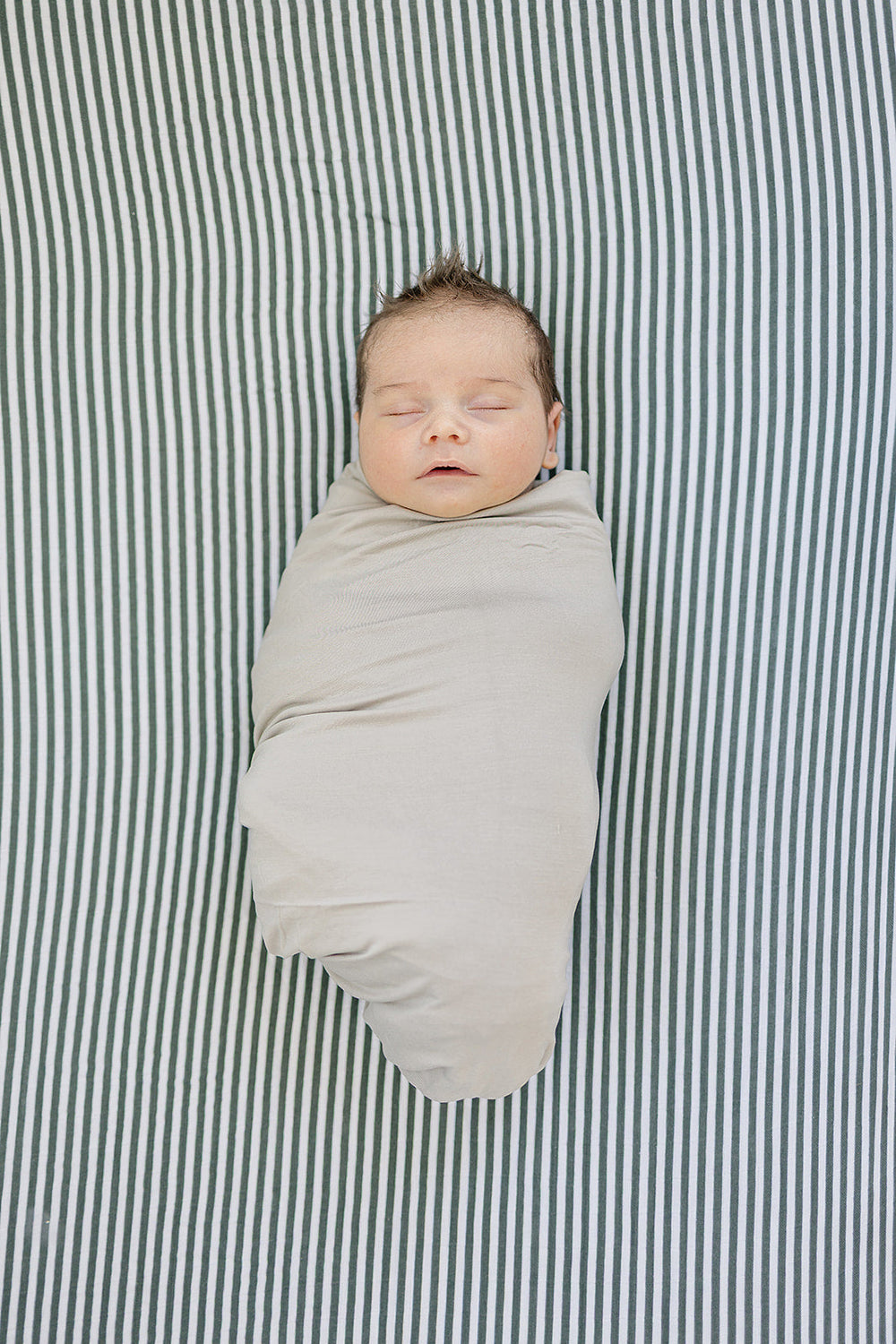 The Mebie Baby Green Stripes Muslin Crib Sheet provides a snug fit, ideal fitted crib sheets for nurseries.