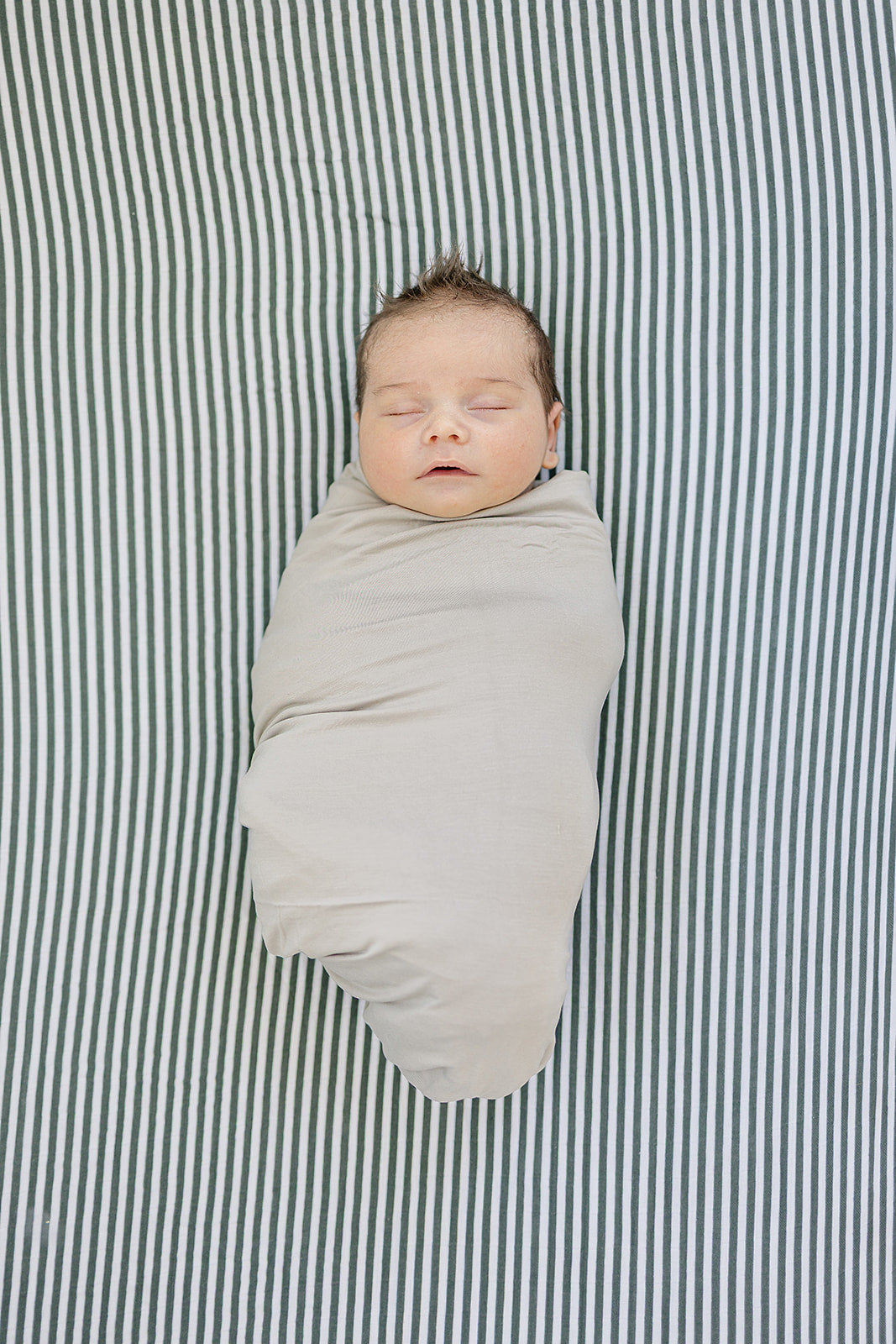 The Mebie Baby Green Stripes Muslin Crib Sheet provides a snug fit, ideal fitted crib sheets for nurseries.
