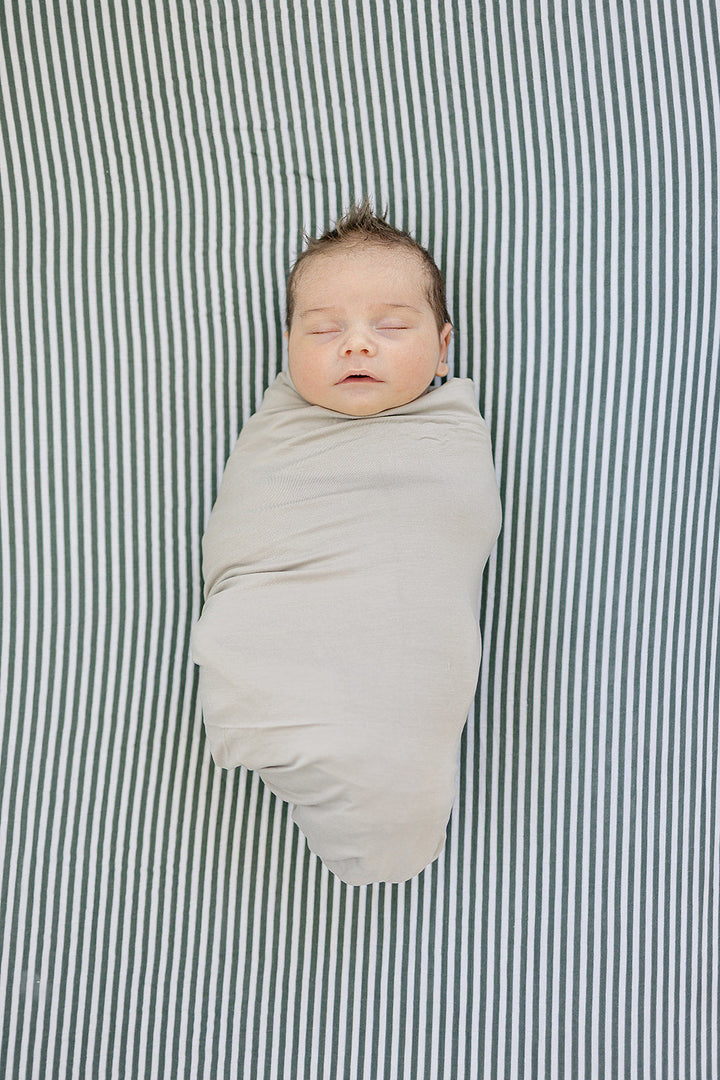 The Mebie Baby Green Stripes Muslin Crib Sheet provides a snug fit, ideal fitted crib sheets for nurseries.