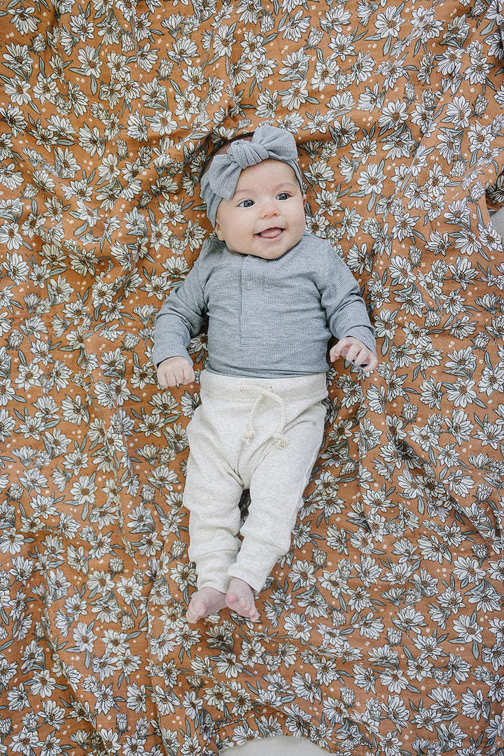 Mebie Baby Heather Grey Bamboo Snap Long Sleeve Ribbed Bodysuit photographed in natural light to show true color