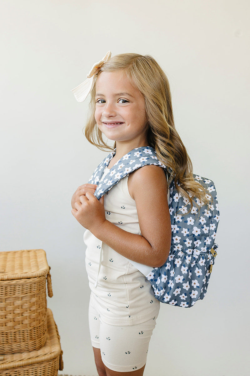 Child wearing the Mebie Baby Green Floral Mini Backpack, a practical kid backpack ideal for little explorers