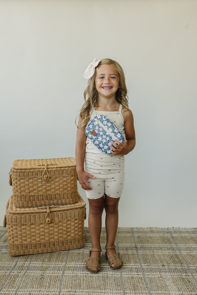 Styled on a child, the Mebie Baby Green Floral Mini Fanny Pack offers hands-free storage as a cute kids fanny pack