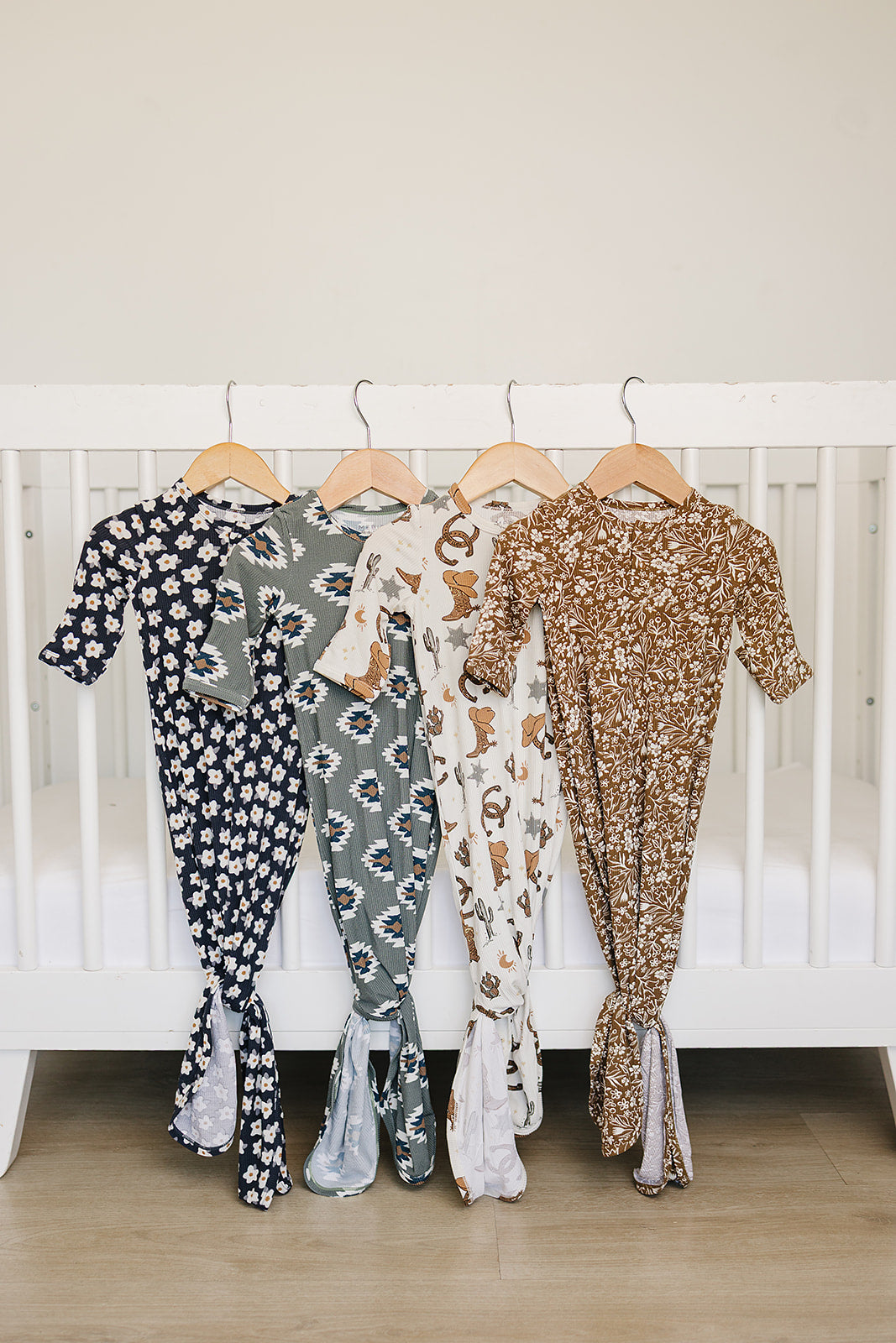 The Mebie Baby Baby Navy Daisy Ribbed Bamboo Knot Gown delivers a cozy feel similar to lightweight onesie pajamas