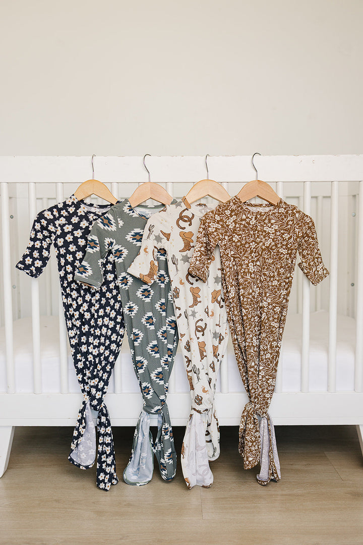 The Mebie Baby Baby Navy Daisy Ribbed Bamboo Knot Gown delivers a cozy feel similar to lightweight onesie pajamas