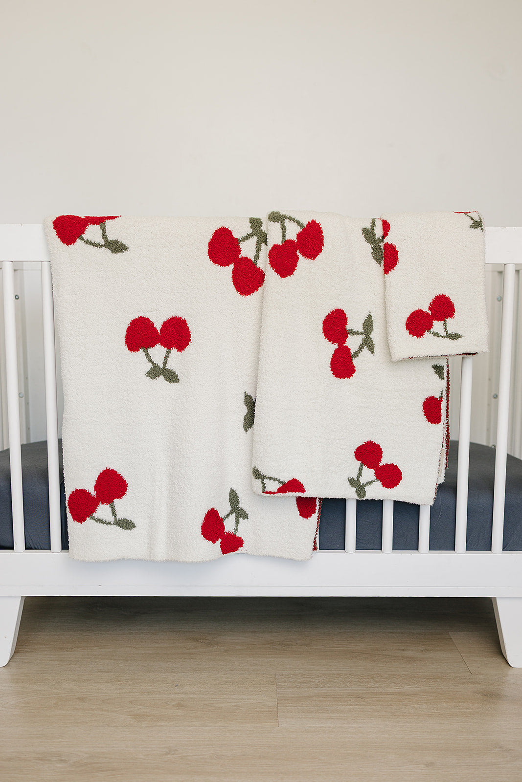 Cuddle your infant in the Mebie Baby Cherry Plush Blanket, a perfect option for baby blankets.