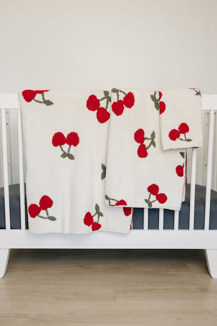 Cuddle your infant in the Mebie Baby Cherry Plush Blanket, a perfect option for baby blankets.