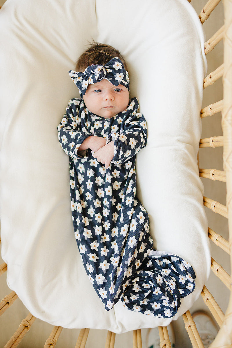Soft ribbed bamboo makes the Mebie Baby Baby Navy Daisy Ribbed Bamboo Knot Gown ideal as breathable bamboo baby pajamas