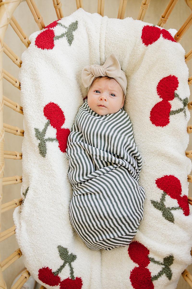 Snuggle your little one in the Mebie Baby Cherry Plush Blanket, one of the best blankets for baby comfort.