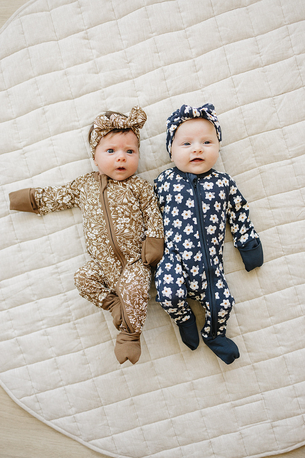 Breathable ribbed bamboo gives the Mebie Baby Navy Daisy Zipper a gentle feel among modern baby onesies