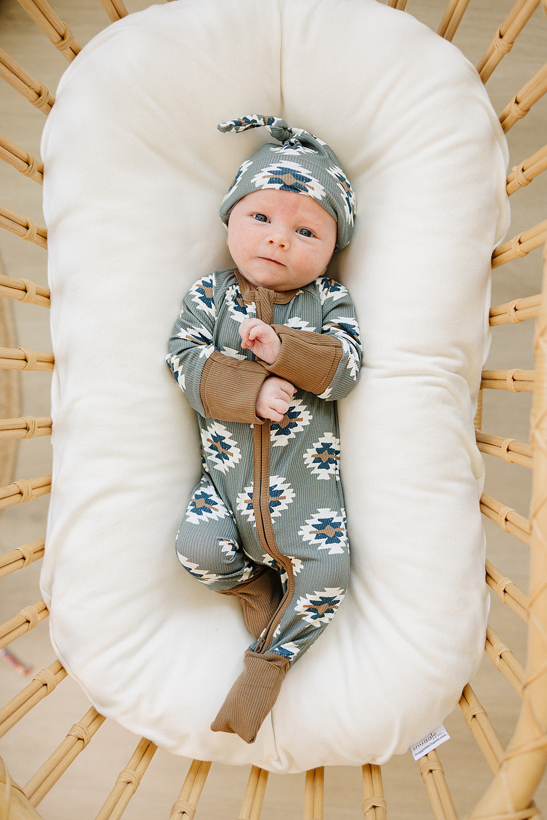 A warm Aztec print highlights the Mebie Baby Southwest Aztec Ribbed Bamboo Zipper, ideal for sweet newborn onesies