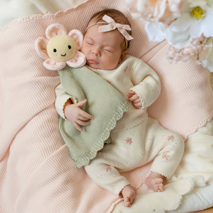 Hand-knit daisy lovey Blush Cuddle + Kind — soft pink flower lovey best baby girl shower gift