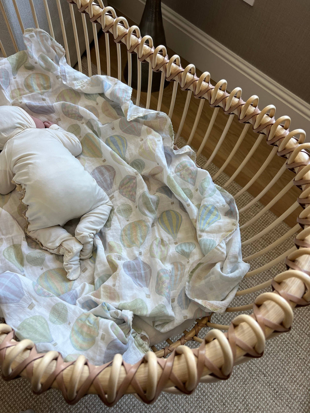 Little Threads muslin baby blanket styled in bassinet, breathable newborn bedding and organic cotton swaddle for supervised comfort
