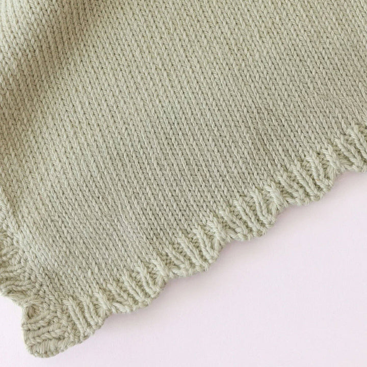Baby Daisy Lovey Blush by Cuddle + Kind — soft pink hand-knit security lovey with daisy flower design