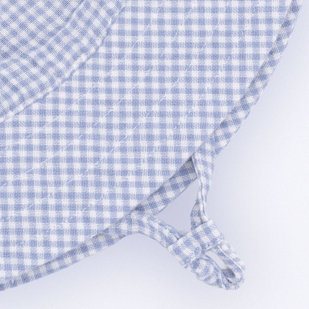 close up of extra safe chin strap for the angel dear wide brimmed infant bucket hat in blue gingham 