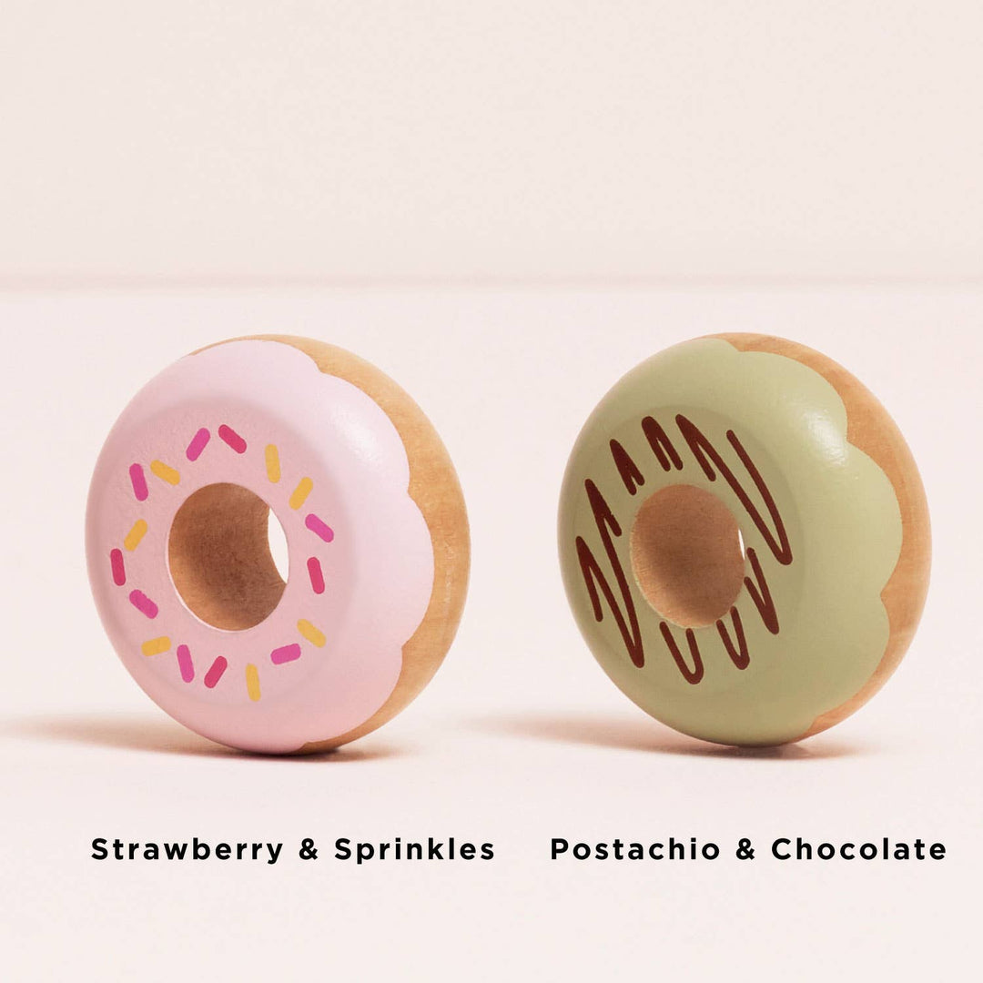 Strawberry sprinkle and pistachio chocolate donuts sit side by side in this Le Toy Van Play Food Set