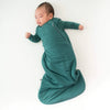 newborn sleeping in emerald Kyte sleepsack