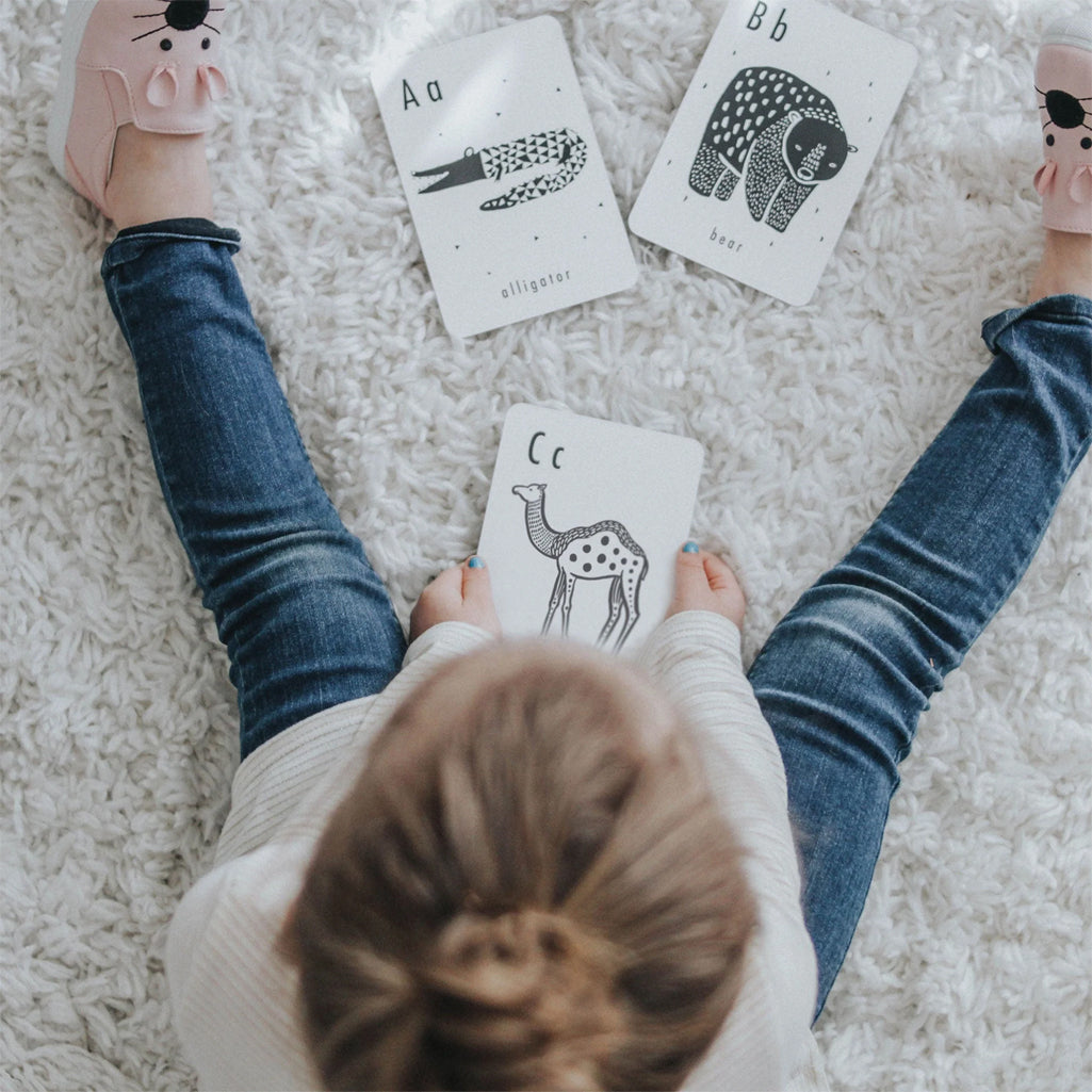 Kid playing with Alphabet cards by wee gallery