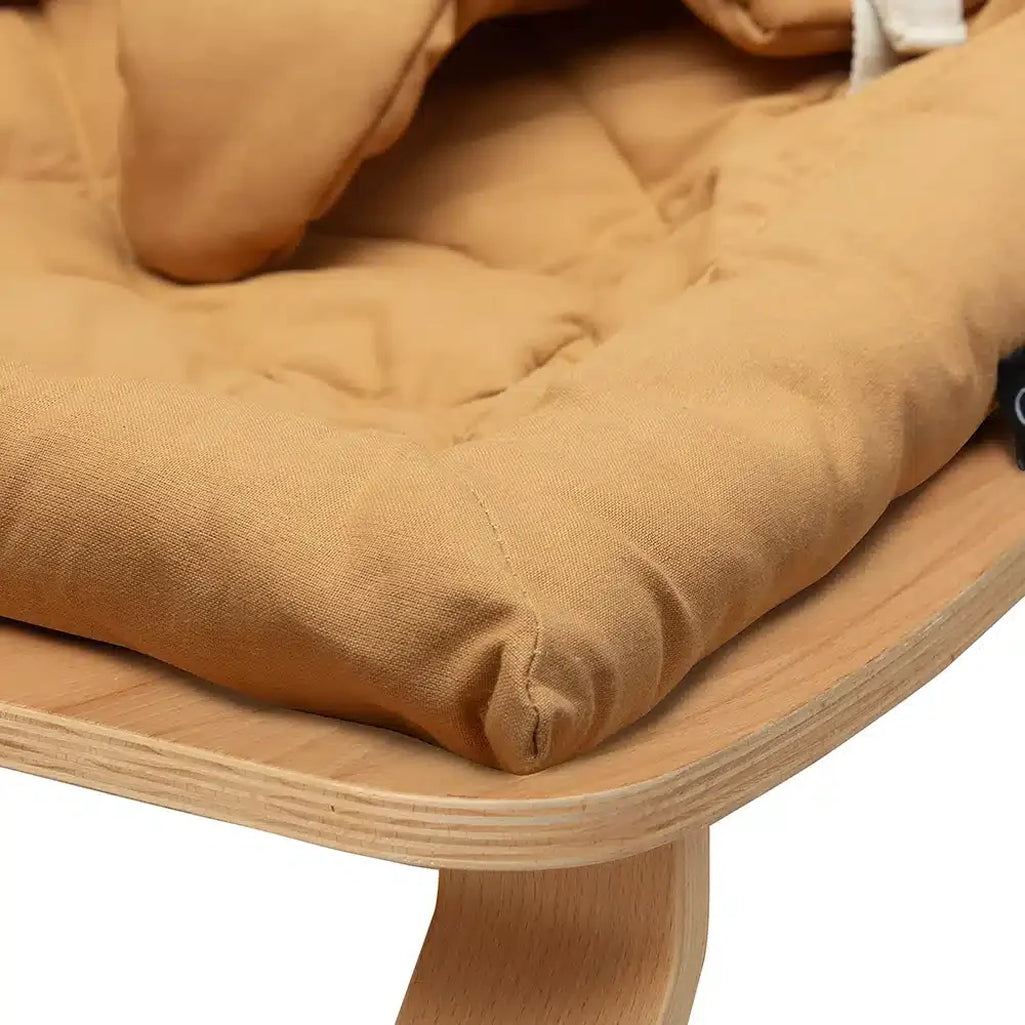 Designed for calm moments, this Charlie Crane Levo Beech Wood Rocker in camel highlights a sustainable wooden build for baby
