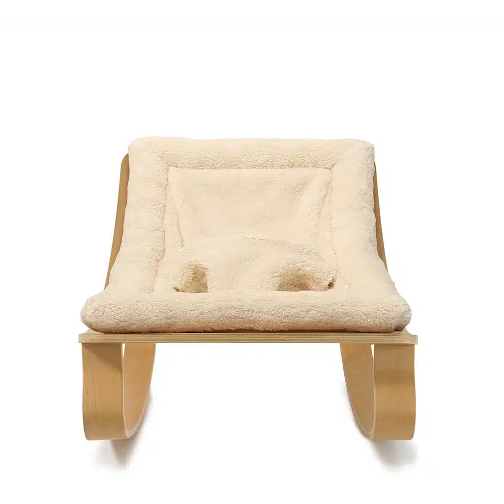 Crafted in beech wood, the Charlie Crane Levo Rocker in milk fur delivers sophisticated French baby seating with comfort