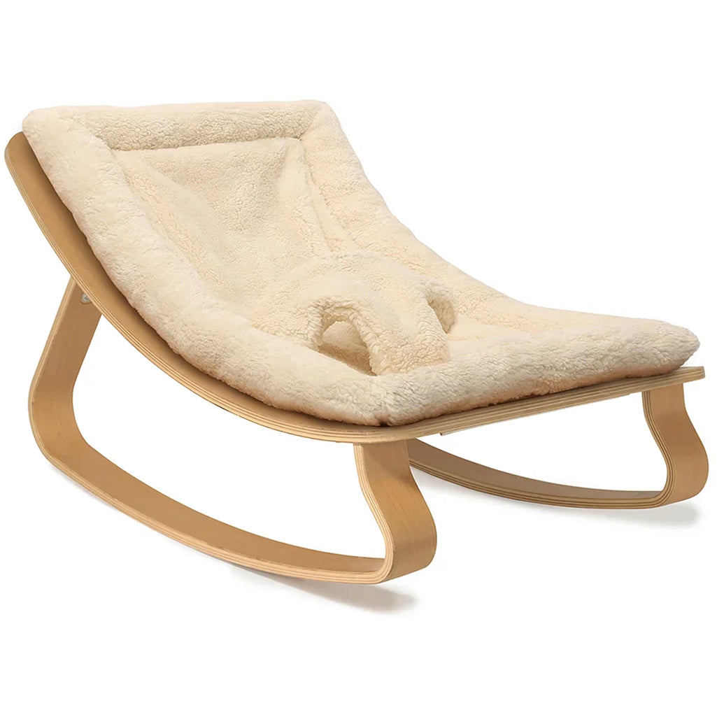 Iconic French design shown in the Charlie Crane Levo Beech Wood Rocker in milk fur, perfect for newborn safe lounging