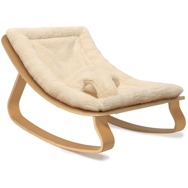 Iconic French design shown in the Charlie Crane Levo Beech Wood Rocker in milk fur, perfect for newborn safe lounging