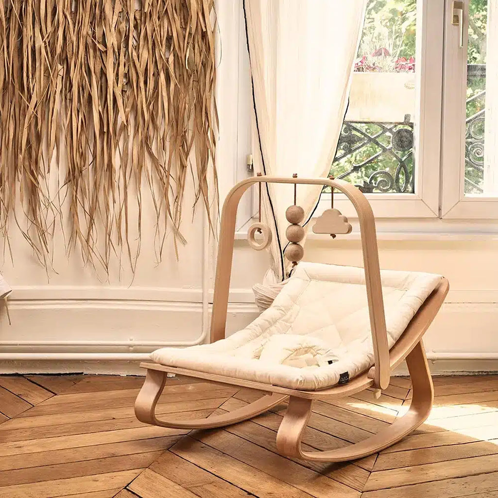 Natural textures shine on the Charlie Crane Levo Rocker in organic milk, a sustainable baby rocker with calm style