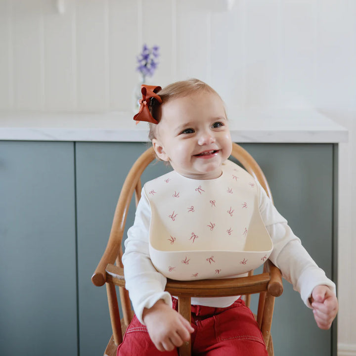 Playful Bows Mushie Silicone Placemat makes childrens placemats practical and pretty.