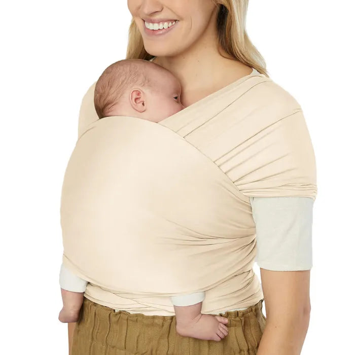 Shown in Cream, the Ergobaby Aura Baby Wrap is a soft baby swaddle wrap made for bonding and comfort.