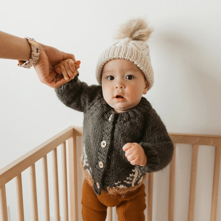A must-have for layering, the Huggalugs Forest Cardigan Loden offers a snug, stylish cardigan fit for every season.