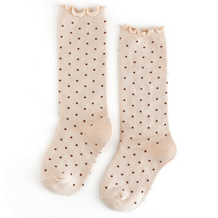 Cream polka dot knee-high socks with ruffled cuffs, the Dottie style in Vanilla from Little Stocking Co.