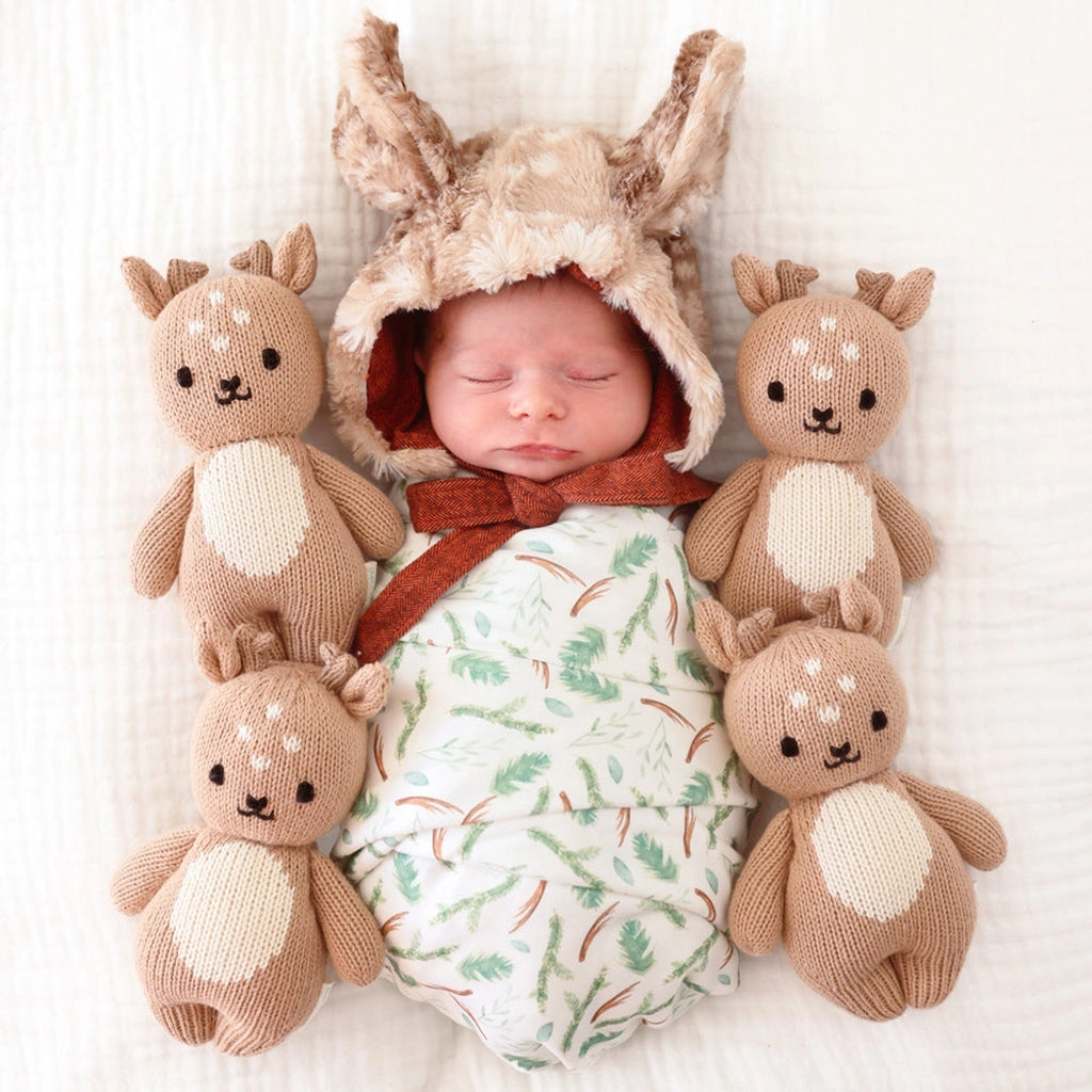 infant with eco-friendly stuffed animals