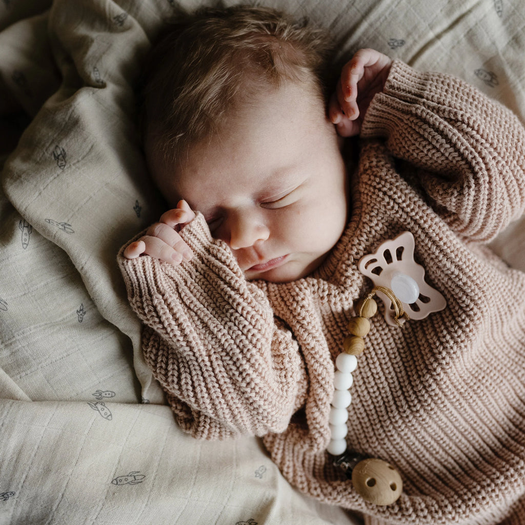 baby sleeping with frigg pacifier