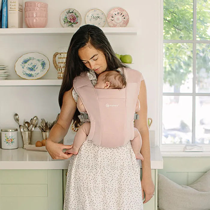 Blush Pink style meets functionality in the Ergobaby Embrace Newborn Carrier, a trusted Ergo baby carrier.