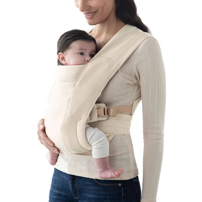 Timeless and neutral, the Cream Ergobaby Embrace Newborn Carrier delivers soft support as a top-rated baby front carrier.