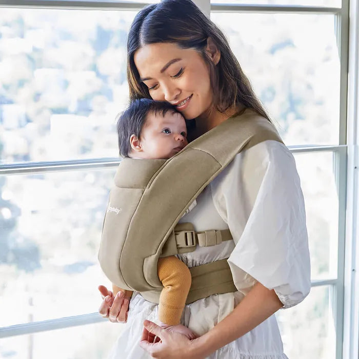 Effortless and cozy, the Olive Ergobaby Embrace Newborn Carrier is one of the best baby carrier for newborn options.