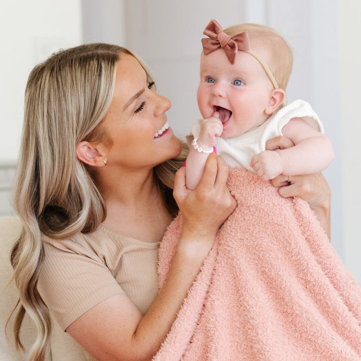 SaranoniÕs BAMBONI¨ Mini Blanket in Peach feels like a hug Ñ a must-have baby blanket for every nursery.