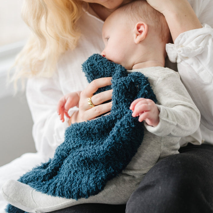 The Saranoni BAMBONI¨ Mini Blanket in Nautical Blue surrounds toddlers in plush luxury, among the best toddler blankets made.