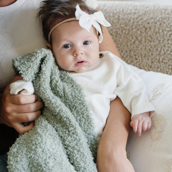 SaranoniÕs BAMBONI¨ Mini Blanket in Sage surrounds little ones in soothing softness, a top pick for soft baby blankets.
