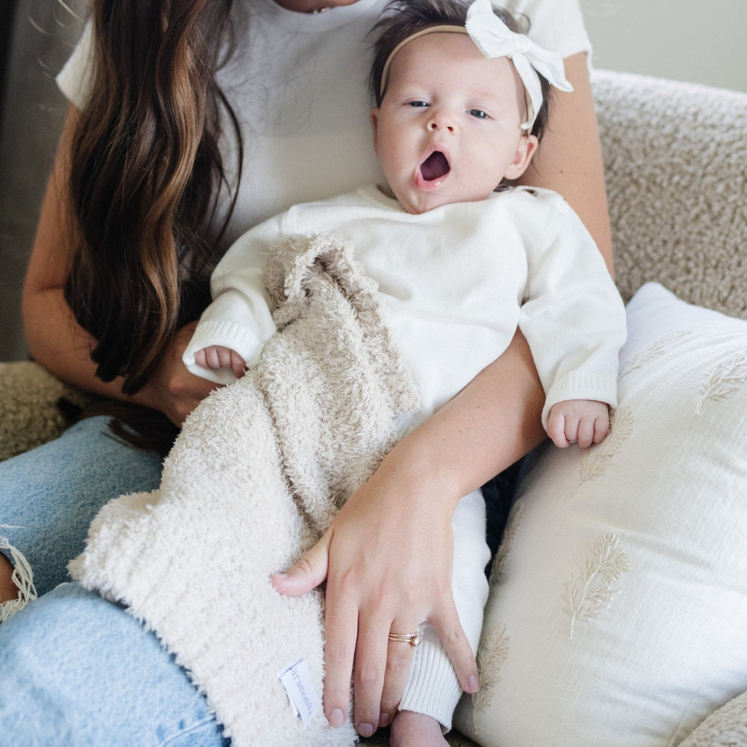 Plush and lightweight, the Saranoni BAMBONI¨ Mini Blanket in Buttermilk brings soft serenity to every cuddle.