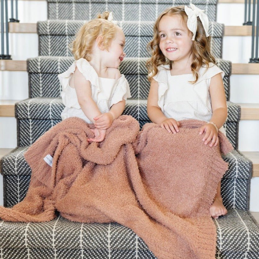 Embrace everyday comfort with the Saranoni Bamboni¨ Receiving Blanket in French Rose, a warm and soft baby blanket.