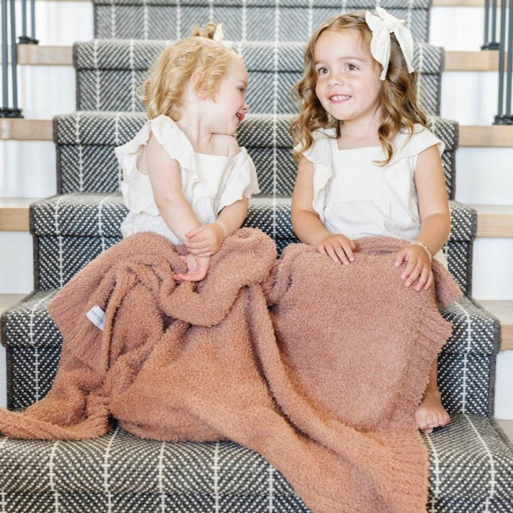 Embrace everyday comfort with the Saranoni Bamboni¨ Receiving Blanket in French Rose, a warm and soft baby blanket.