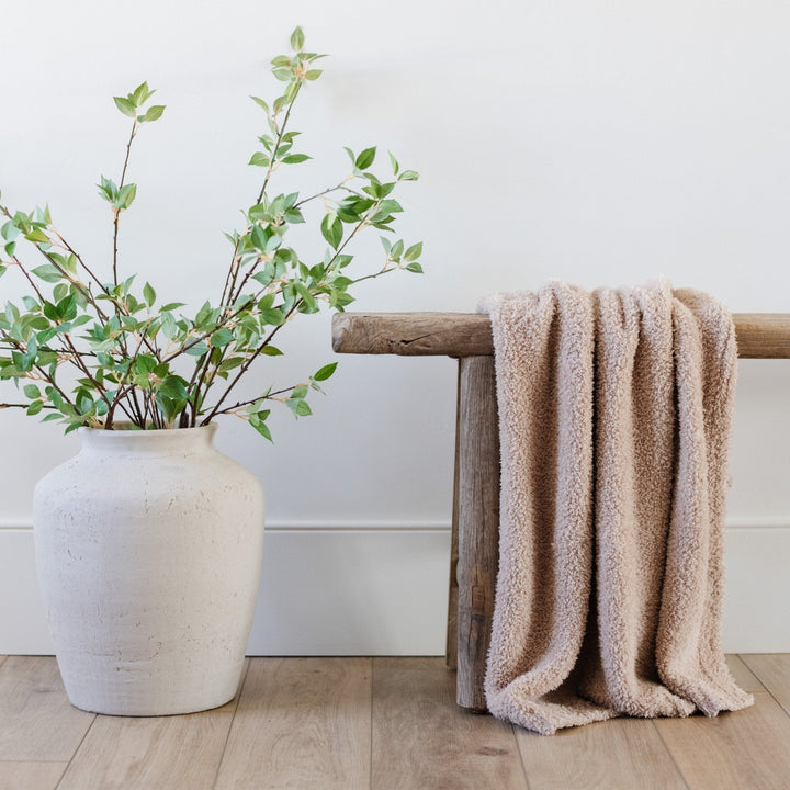 The Saranoni Bamboni¨ Receiving Blanket in Birch adds cozy charm, making it one of the best baby girl blankets.