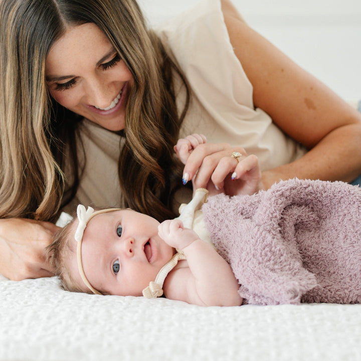 Wrap your newborn in plush softness with the Saranoni Bamboni¨ Receiving Blanket in Woodrose, a gentle baby blanket for all seasons.