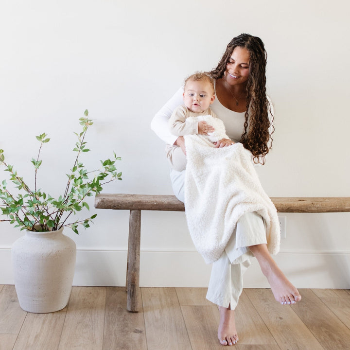 Wrap your newborn in the gentle embrace of the Saranoni Bamboni¨ Receiving Blanket in Ivory.
