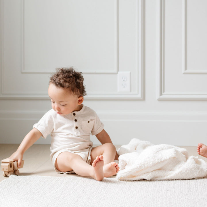 The Saranoni Bamboni¨ Receiving Blanket in Ivory adds cozy warmth to your nursery, a great baby blanket choice.
