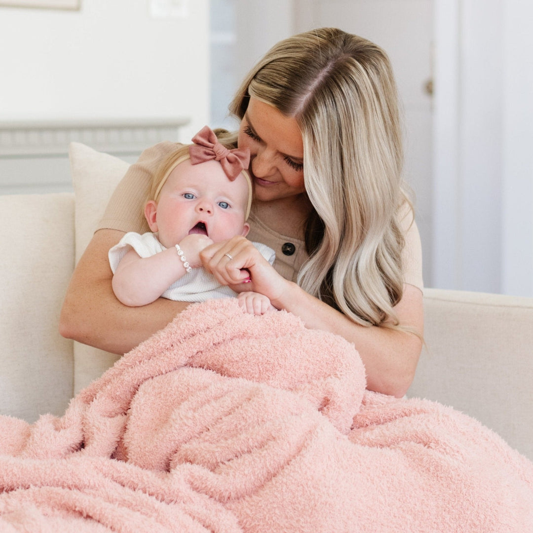 Experience unmatched softness with the Saranoni Bamboni¨ Receiving Blanket in Peach, a dreamy baby blanket.