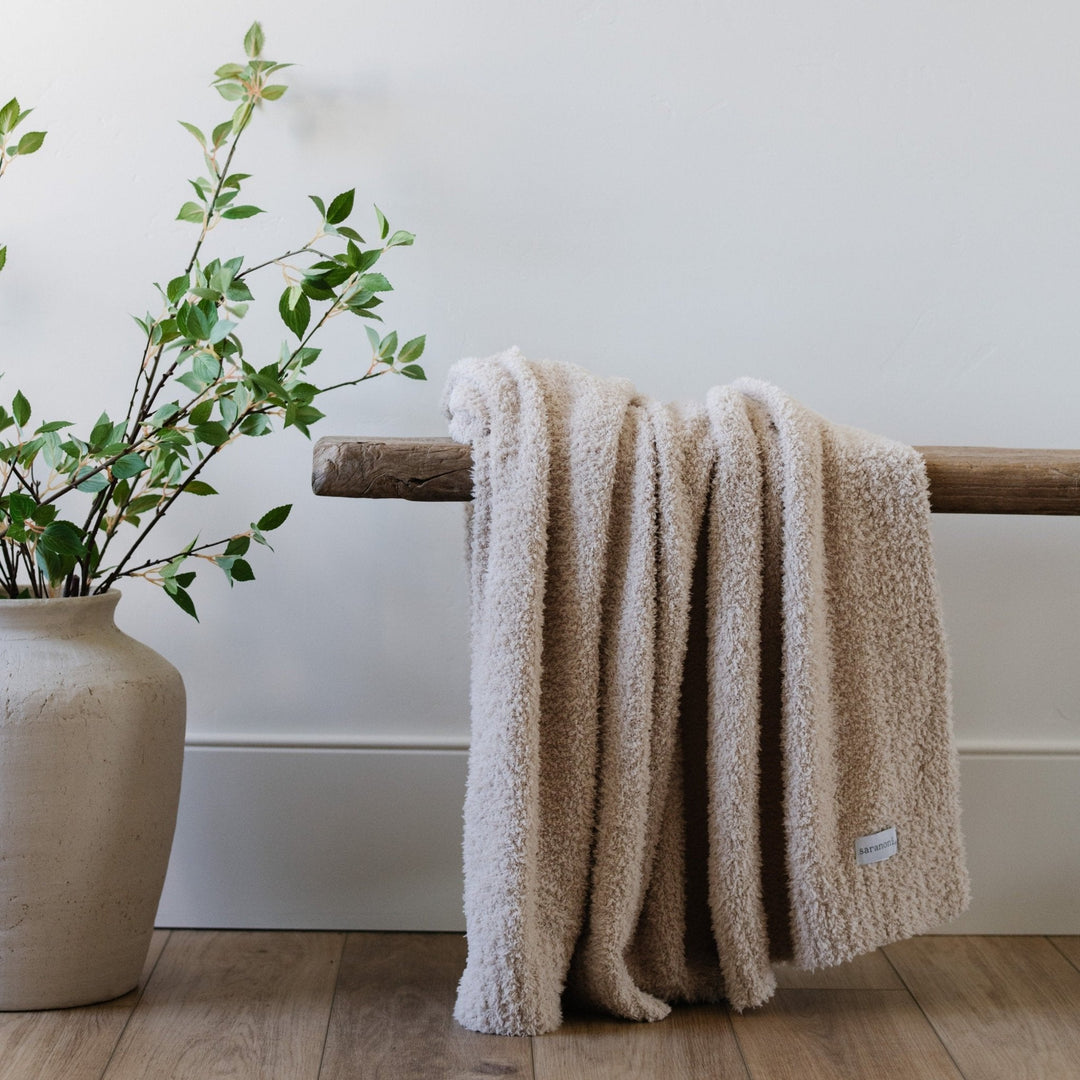 Bring soothing warmth with the Saranoni Bamboni¨ Receiving Blanket in Buttermilk, the perfect infant receiving blanket.